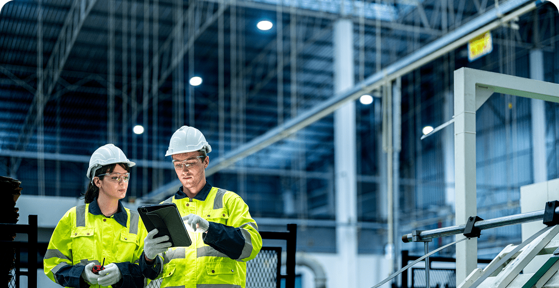 Workers in safety gear at a plant