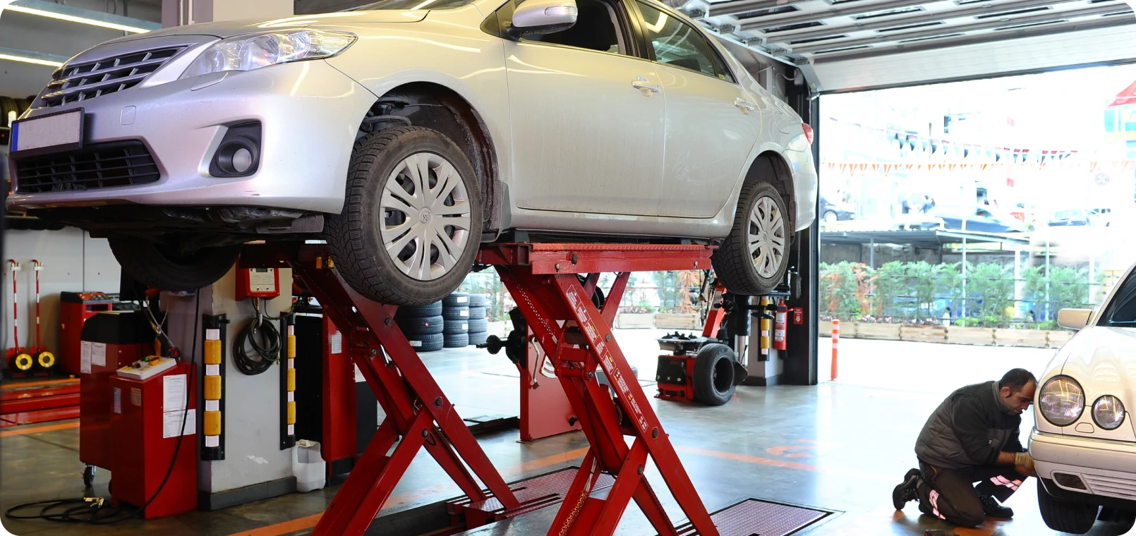 Car on lift in auto repair shop